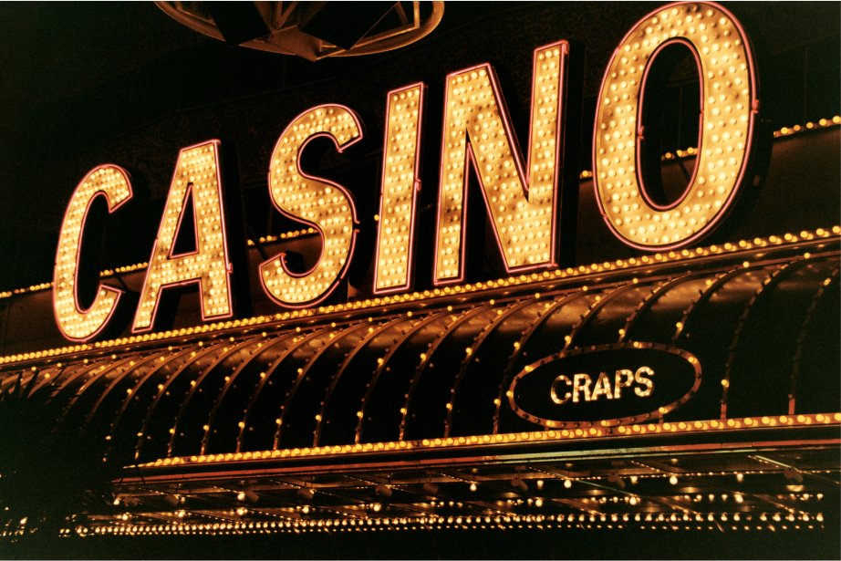Casino neon sign with CRAPS marquee — the house edge is real